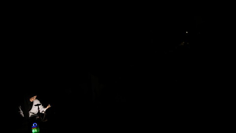 Beirut in darkness; two people smoke an arguileh in the dark. Beirut, Lebanon. August 28, 2020. (Marwan Tahtah/The Public Source)