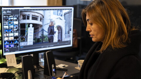 Amal Khalil at her desk in the Al-Akhbar office, editing an upcoming episode of her newly launched program, Ahel al-Ared (The People of the Land).