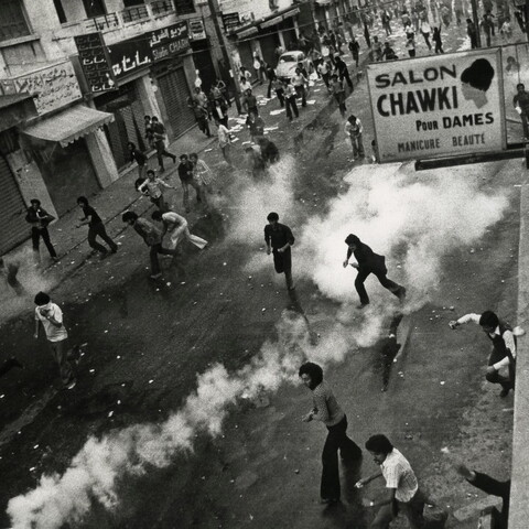 A scene from one of the confrontations on Hamra Main Street, where tens of students charge, amid tear gas, some of them armed with stones.