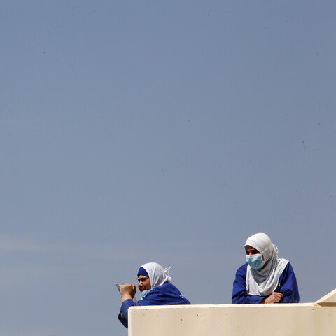 Healthcare workers take a break outside Rafik Hariri University Hospital. Beirut, Lebanon. April 17, 2020. (Marwan Tahtah/The Public Source)