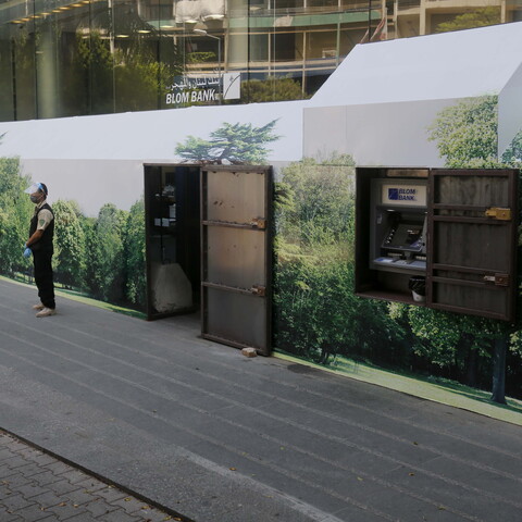 Bank in Beirut protected by two private security guards and a metal wall. 