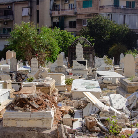 The photo shows several damaged tombstones in Beirut's Bachoura Cemetery. 