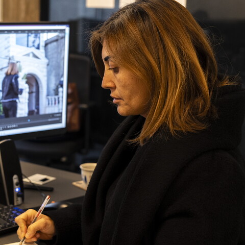 Amal Khalil at her desk in the Al-Akhbar office, editing an upcoming episode of her newly launched program, Ahel al-Ared (The People of the Land).