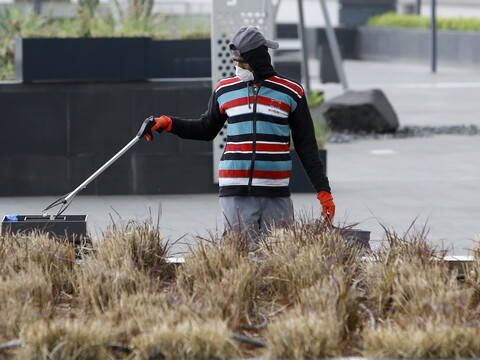 A street sweeper wearing a mask is cleaning empty streets. Beirut, Lebanon. March 18, 2020. (Marwan Tahtah/The Public Source)