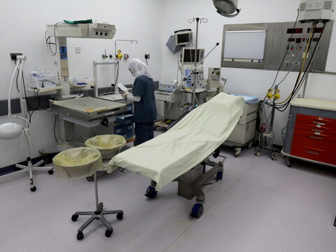 A health worker prepares an operation room.
