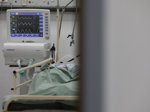 A monitor displays the vital signs of a patient.