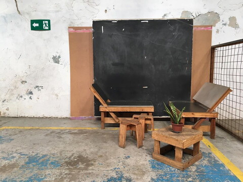 A picture of a wooden divan and a chair at the public clinic of psychoanalysis in Vila Itororo. Sao Paulo, Brazil.