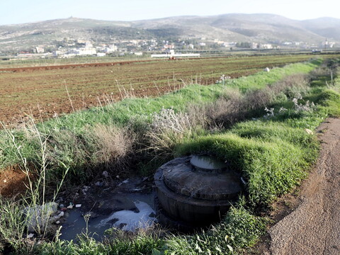 Open manhole pouring sewage water into a canal bordering an agricultural land in Akkar.
