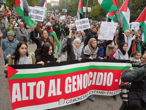 Men and women gather in Madrid with placards, keffiyehs, and Palestinian flags to protest against Israel’s attacks in Gaza. 