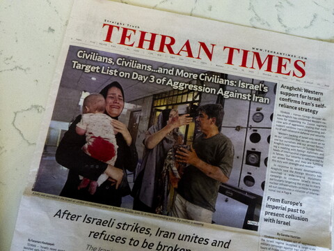 Front page of Tehran Times newspaper on the third day of the Israeli war on Iran showing distressed civilians and a woman carrying a child with a bloodied diaper.