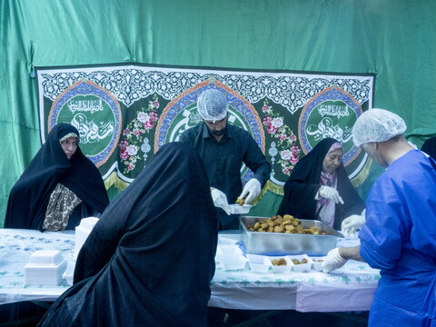 People distributing food in Enqelab Square in Tehran, Iran, to commemorate Eid al-Ghadir, an important holiday observed by Shi'a Muslims. 