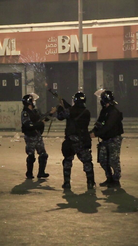 Lebanese riot police officers fire shots into the air in Nour Square. Tripoli, Lebanon. January 27, 2021. (Abedal Kader Albai/The Public Source)