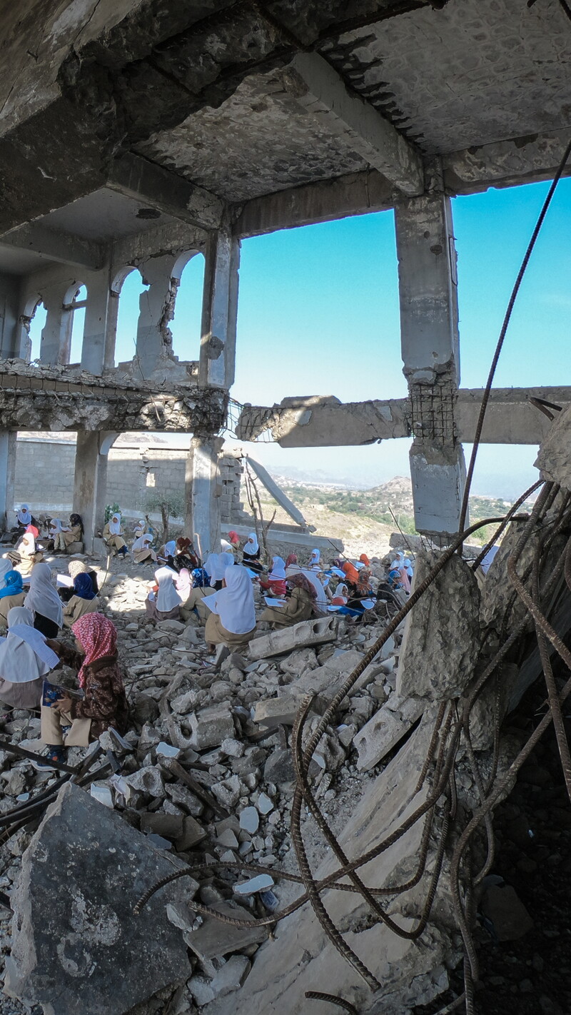 Children study in the rubble of their school that was destroyed by the violent war in the city of Taiz, Yemen. December 27, 2018. (Akram Alrasny/Shutterstock)