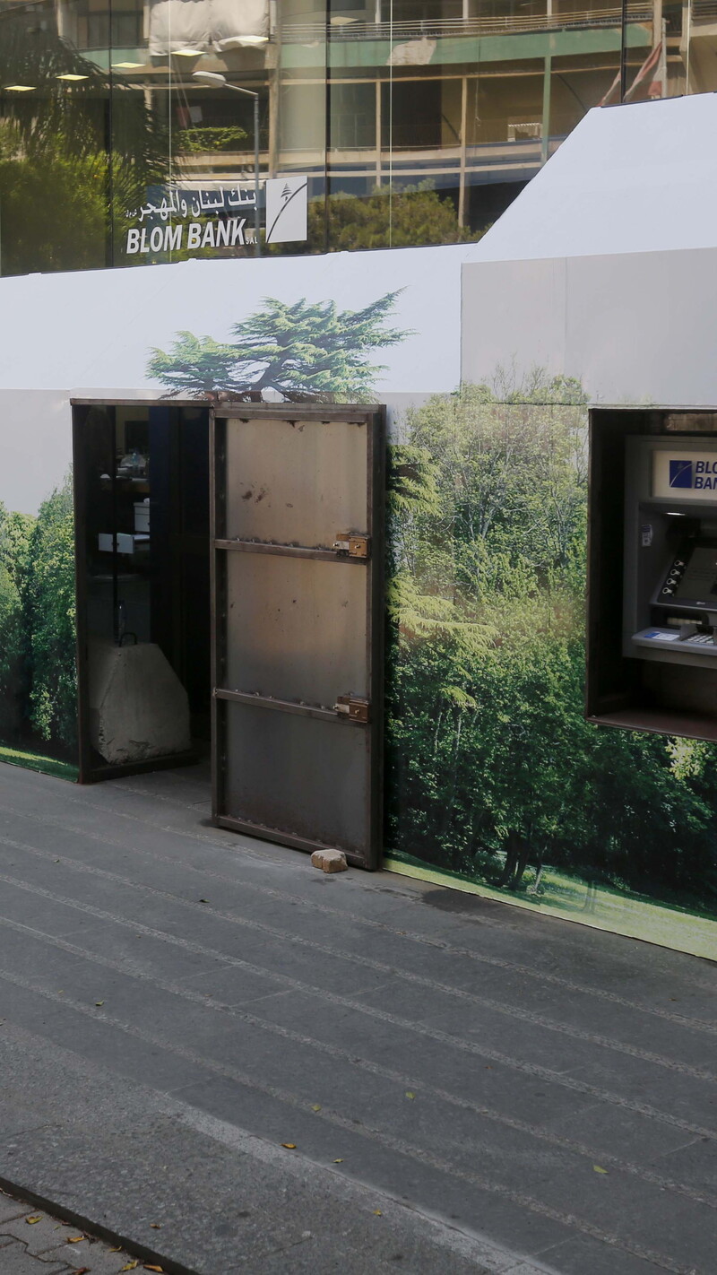 Bank in Beirut protected by two private security guards and a metal wall. 