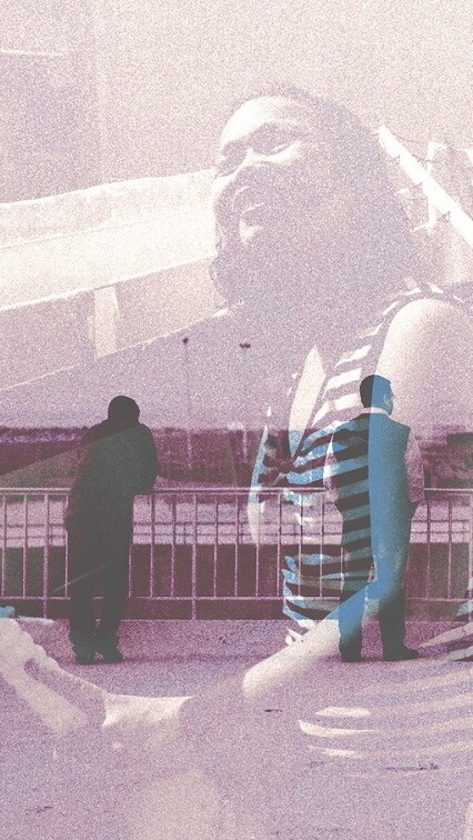 A composite of two images: a woman in the foreground, and people standing at a railing in the background, looking outward. There is a mosque on the horizon.