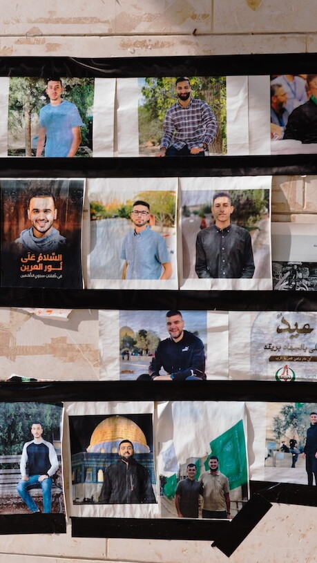 Pictures of student martyrs and prisoners are displayed outside the student council office at Birzeit University. 