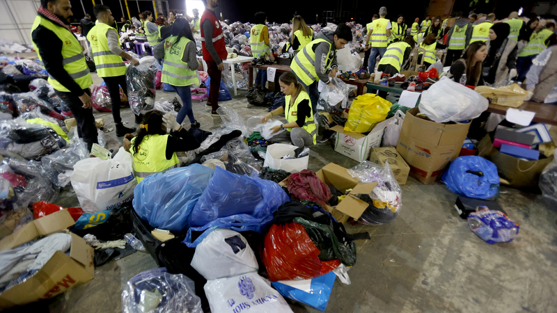 Volunteers sort donated food and clothes for the annual winter Dafa Campaign in Beirut, Lebanon. December 19, 2019. (Marwan Tahtah/The Public Source).
