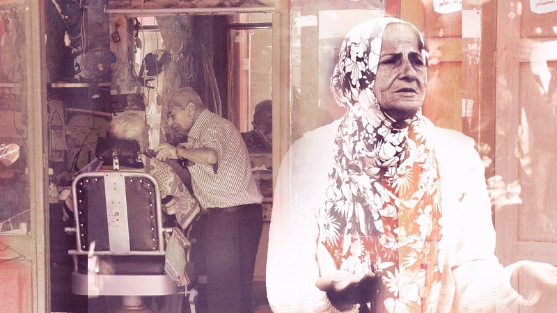 A composite of a senior woman protesting during the October 2019 uprising in the foreground against an old Mar Mkhayel barber shop in the background.