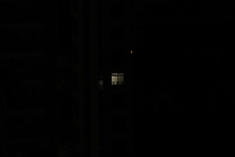Beirut in darkness; a lit up window. Beirut, Lebanon. August 28, 2020. (Marwan Tahtah/The Public Source)