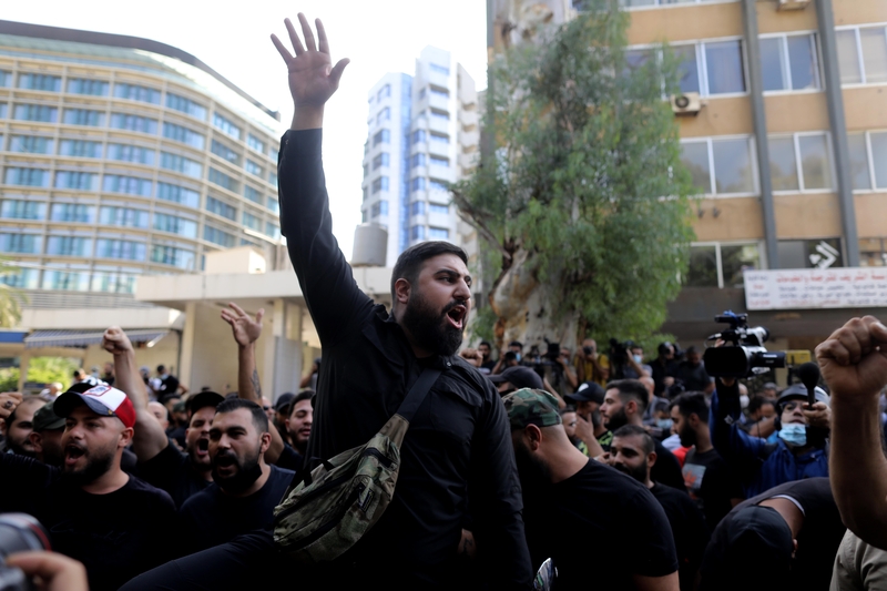 Hundreds of protesters sporadically marched the streets chanting, "With our souls, with our blood, we will sacrifice ourselves for you Nabih!” Others sang, "He’s a judge and he’s playing with fire; he's directed by the embassies; go on leave, Bitar! Go on, leave, Bitar!” Adlieh, Lebanon. October 14, 2021. (Marwan Tahtah/The Public Source)