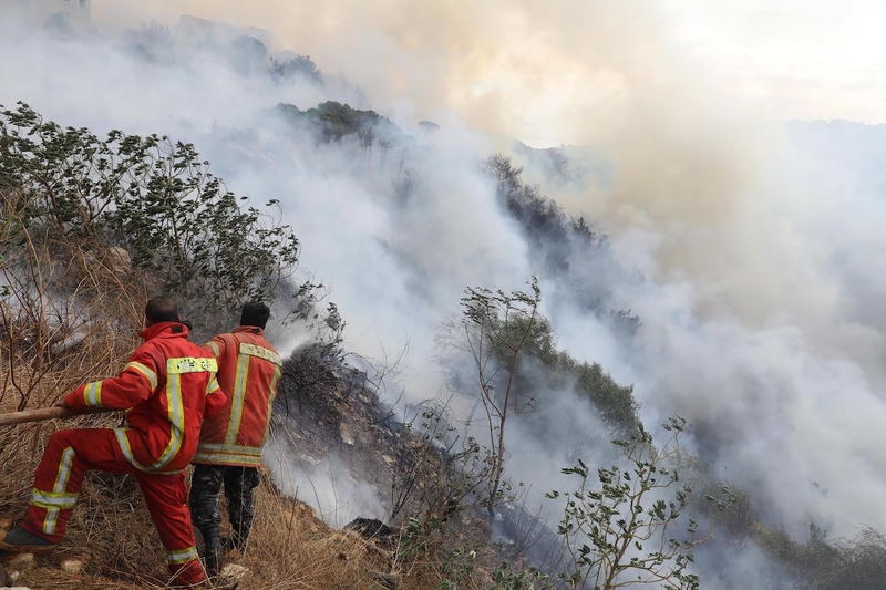 Firefighters extinguishing a forest fire in Bchamoun.