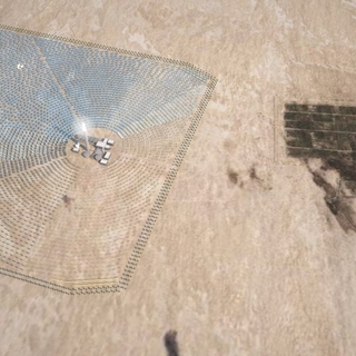A rendered, aerial image of a solar panel field in a desert.