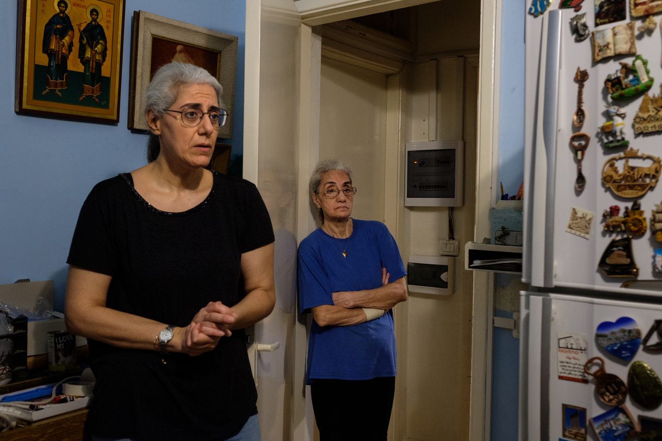 Two women stand in their kitchen