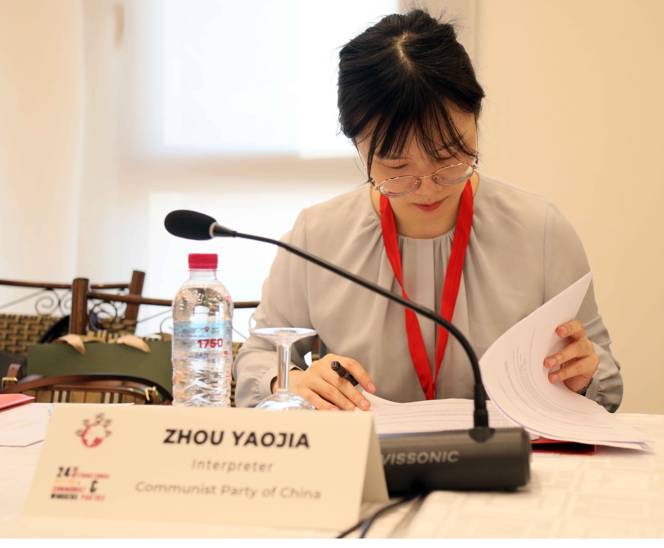 Conference delegate looks at her papers