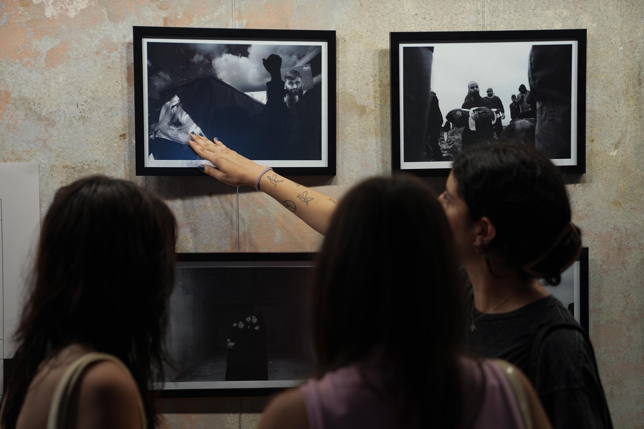 Three women look at photographs