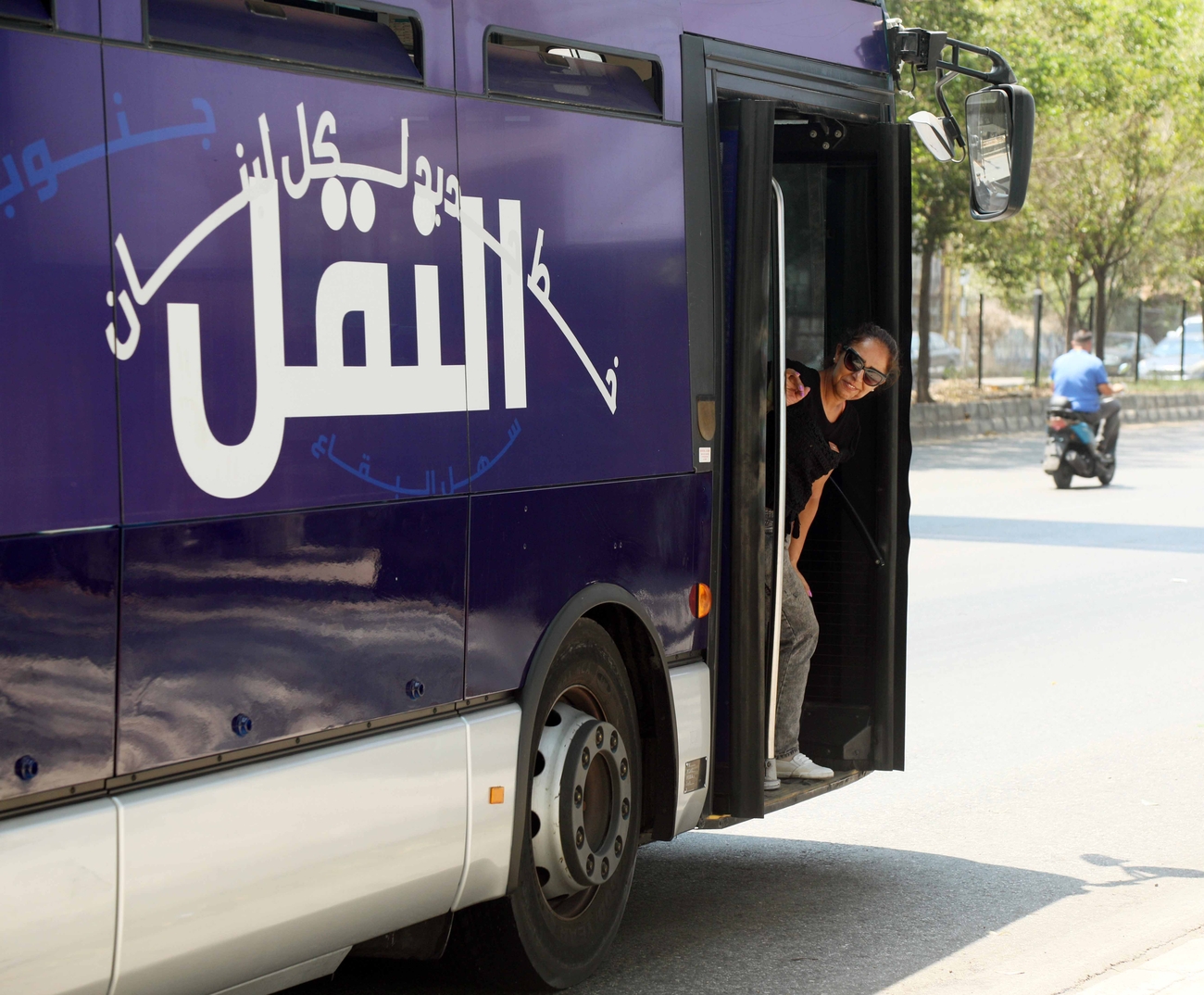 Woman looks out of bus