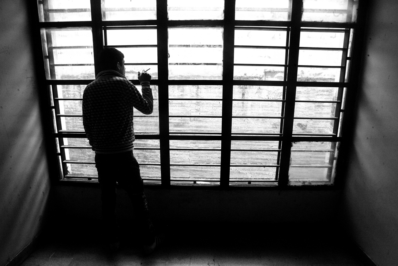 A man looks out the window from Roumieh prison