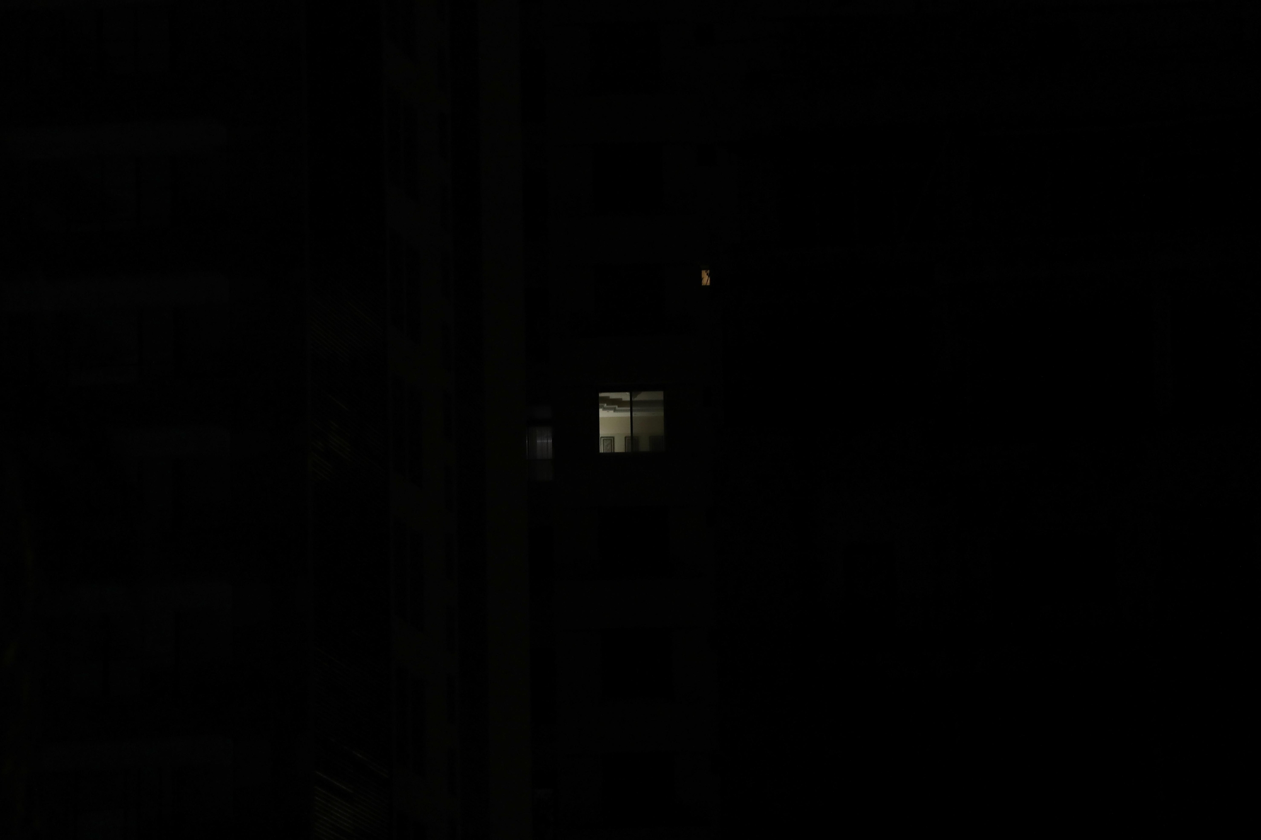 Beirut in darkness; a lit up window. Beirut, Lebanon. August 28, 2020. (Marwan Tahtah/The Public Source)