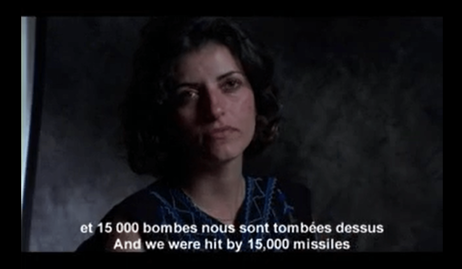 A screenshot from a film; the subtitles read: "And we were hit by 15,000 missiles"