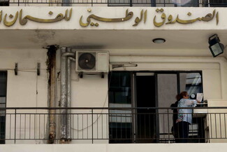 A worker browses through a filing cabinet on a balcony of the NSSF branch in Cola.