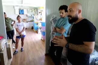 Four team members from the By Bee collective stand in the equipment room.