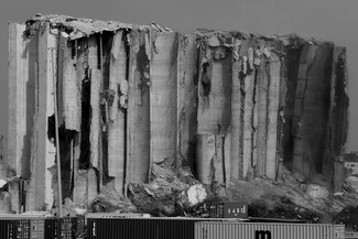 A black and white close-up of the grain silos after the fire died down. 