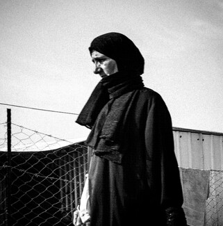 صورة بالأبيض والأسود لامرأة نازحة في أحد المخيمات في رفح. رفح، قطاع غزة المحاصر. (مؤيد أبو أمونة، مصدر عام)
