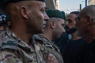 Security forces prevent men from entering Hamra Star, while a number of women and children remain inside. Beirut, Lebanon. October 21, 2024. (Fatima Joumaa/The Public Source)