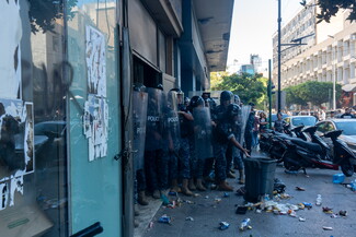 The Internal Security Forces surround the Hamra Star entrance and prevent displaced residents from entering the building. Beirut, Lebanon. October 21, 2024. (Fatima Joumaa/The Public Source)