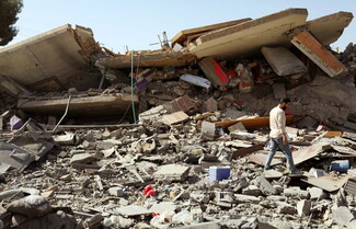 Man walks through rubble in Duris, Baalbek-Hermel