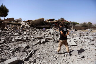 Man walks through rubble in Duris, Baalbek-Hermel
