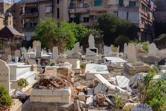 The photo shows several damaged tombstones in Beirut's Bachoura Cemetery. 