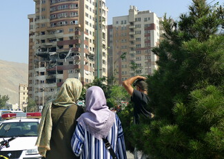 Two women standing in front of a building in Sa'adat Abad, Tehran.