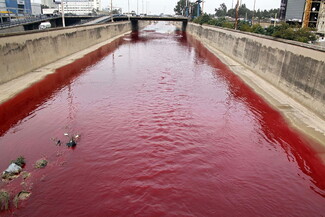 The Beirut River stained red, evoking the sight of blood.