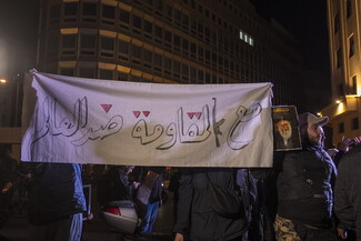 Beirut’s Riad al-Solh Square filled with people protesting. Protestors carried a banner that reads: “With the resistance against the world.”