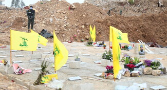 Hezbollah flags placed on several graves in a cemetery in Dahieh, Beirut.