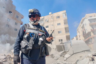 A Civil Defense member on duty stands above the rubble, watching his colleagues rescue people trapped beneath it in the al-Raml neighborhood of Sur. South Lebanon, Lebanon. April 8, 2026.