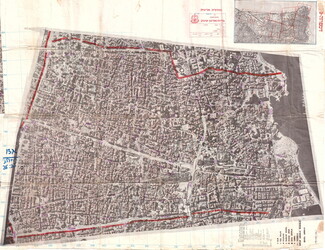 A large, detailed black-and-white aerial surveillance map of the dense grid of Beirut city, marked with a fine grid pattern and prominent red lines outlining specific regional boundaries.