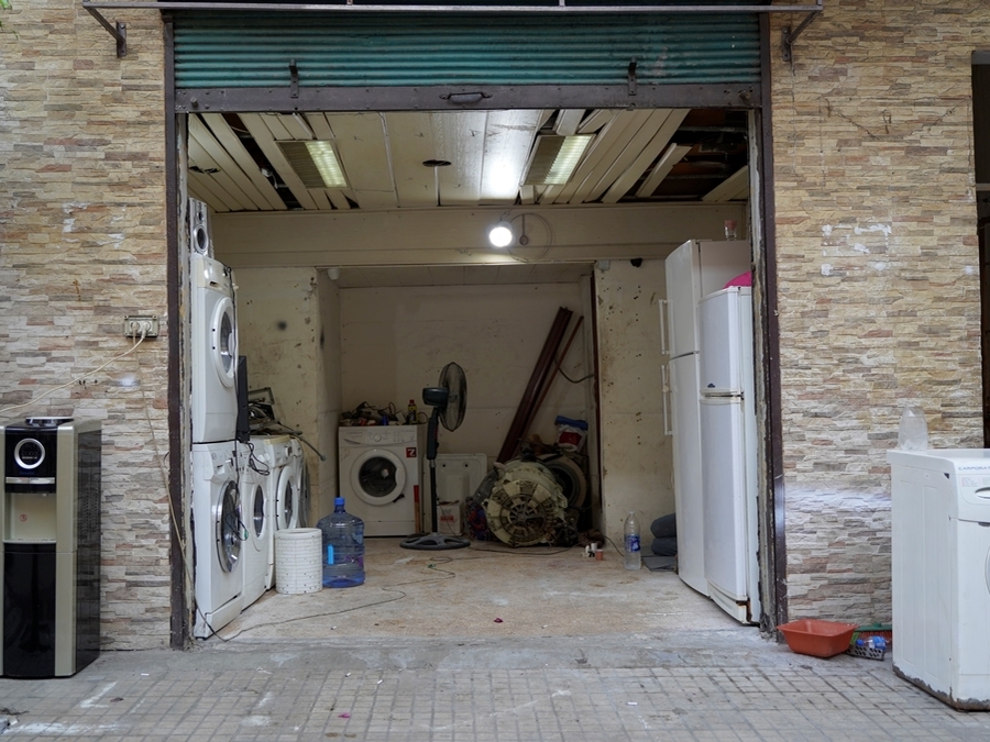 With new appliances now unaffordable, repair shops for washing machines, stove tops, and fridges have become a common sight in the neighborhood. Nabaa, Lebanon. June 26, 2021. (Mohamad Cheblak/The Public Source)