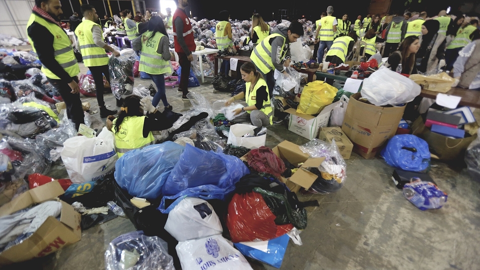Volunteers sort donated food and clothes for the annual winter Dafa Campaign in Beirut, Lebanon. December 19, 2019. (Marwan Tahtah/The Public Source)